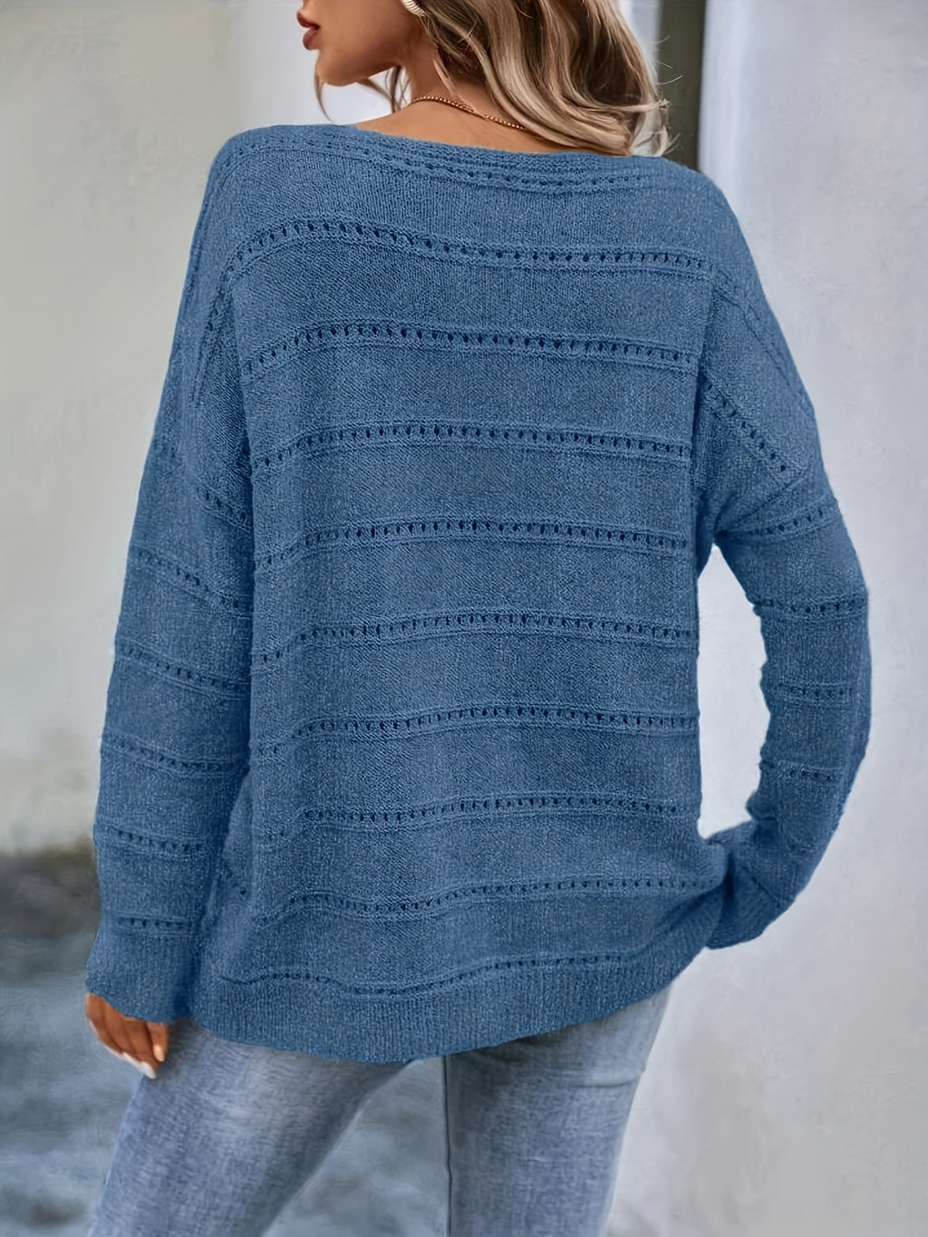 Crew-neck pullover sweater with drop shoulders and loose, relaxed fit for casual all-season wear