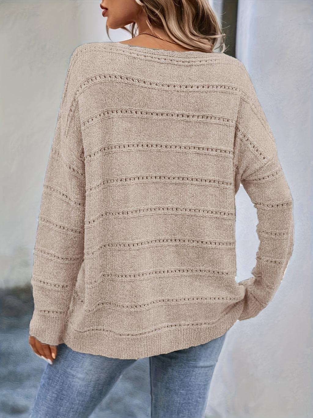 Crew-neck pullover sweater with drop shoulders and loose, relaxed fit for casual all-season wear