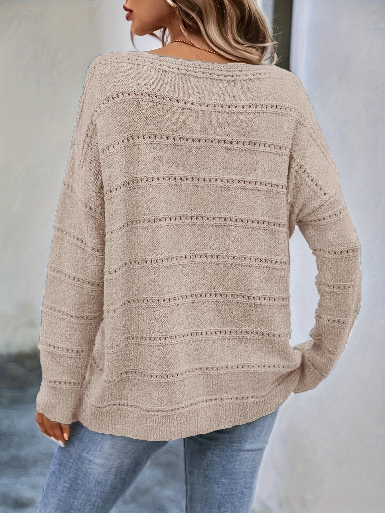 Crew-neck pullover sweater with drop shoulders and loose, relaxed fit for casual all-season wear