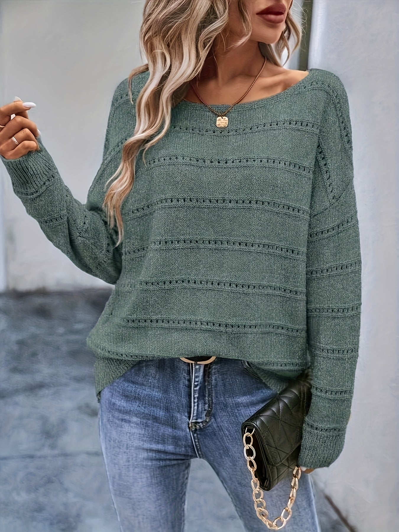 Crew-neck pullover sweater with drop shoulders and loose, relaxed fit for casual all-season wear