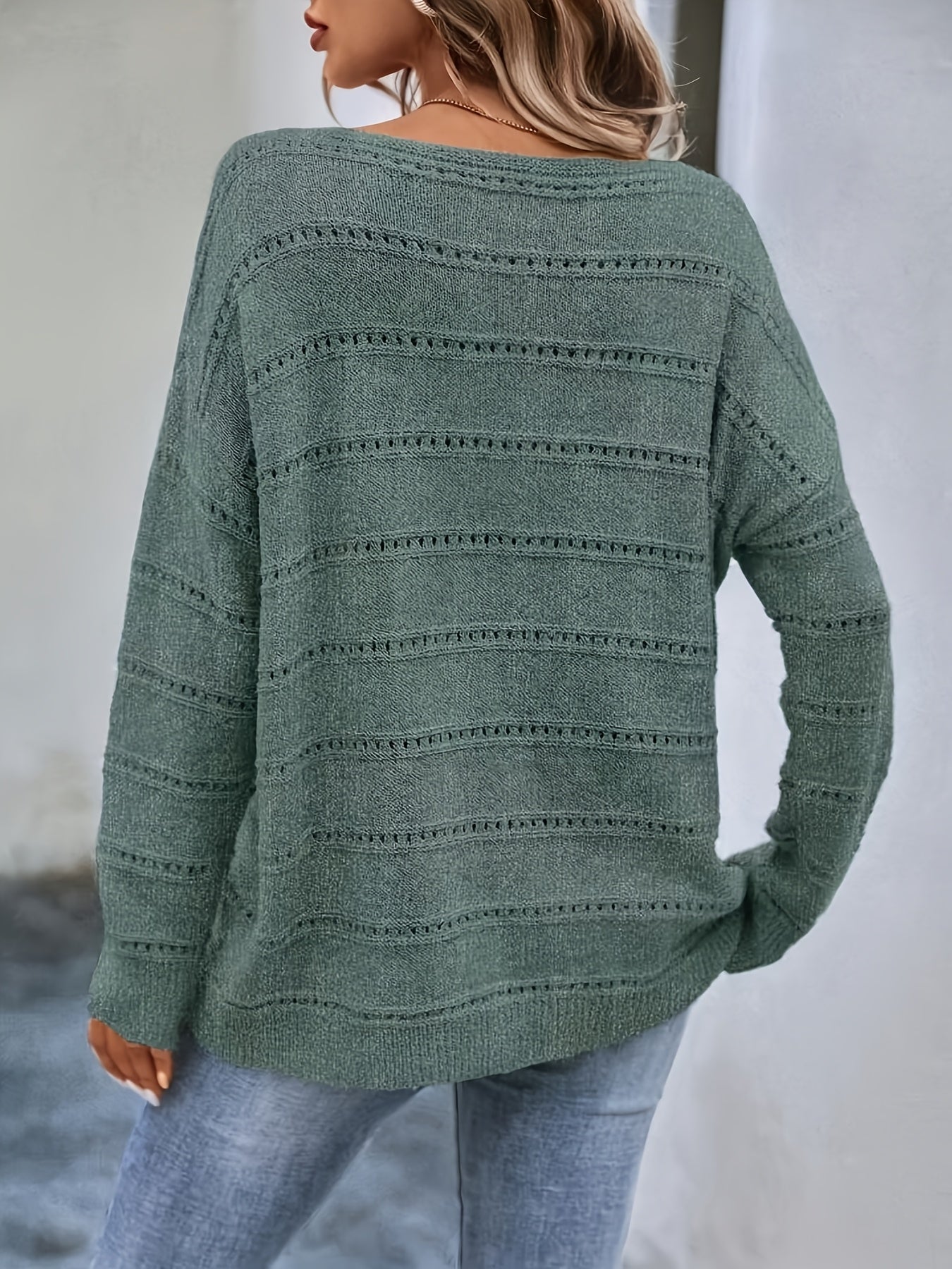 Crew-neck pullover sweater with drop shoulders and loose, relaxed fit for casual all-season wear